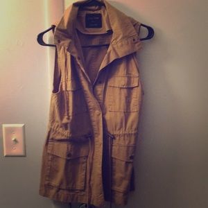 Tan vest with hood.